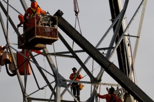 Team of workers installing the transmission tower 